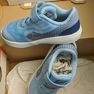 Baby blue Nike revolution tennis shoes